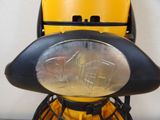 a close up of a yellow and black motorcycle with a helmet on it