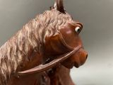 statue of a brown horse with a bridle on it ' s head