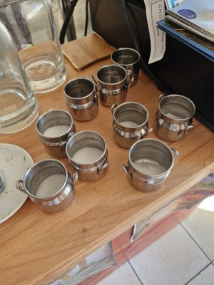 a wooden table with a bunch of cups and plates on it
