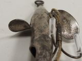 a metal object with a spoon and spoon rest on it