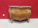 a small wooden chest of drawers with marble top