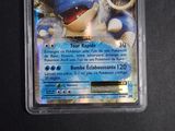 a pokemon card in a plastic container on a table