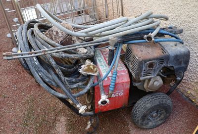 a pile of hoses sitting on the ground next to a machine