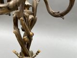 a metal candelab with a bird on top of it