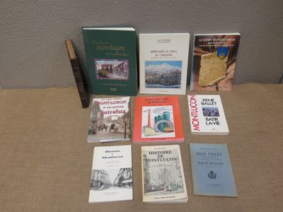 several books are sitting on a table in front of a wall