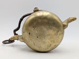 an old brass teapot with a handle on a white background