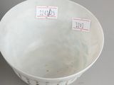 a white bowl sitting on a table with labels on it
