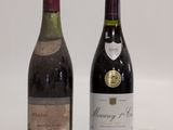two bottles of wine sitting next to each other on a table