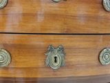 a wooden chest of drawers with brass knobs on it