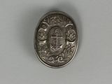 a close up of a silver coin with a coat of arms on it