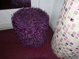 a purple ball sitting on the floor next to a mirror