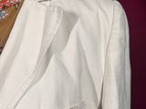 a mannequin wearing a white suit and tie on a mannequin