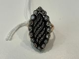 black and white diamond ring on a white surface