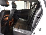 the back seats of a white car with black leather seats