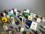 a lot of different types of perfumes on the table