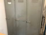 two metal lockers in the corner of a room