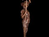 a bronze statue of a man holding a spear and a star