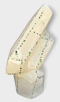 a piece of cheese that is sitting on top of a block of cheese