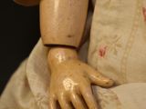 a doll that has a hand on it ' s arm