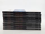 six books stacked on top of each other on a white surface