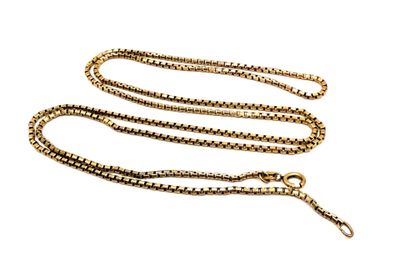 a close up of a gold chain on a white background