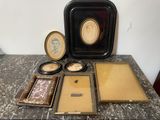 a lot of picture frames and a picture frame on a table