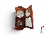 a wooden clock with a mirror in the middle of it