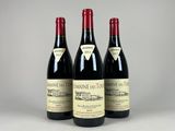 three bottles of wine sitting on top of a table
