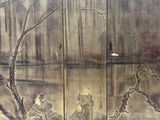 a painting on the wall of a building with a man sitting on a bench in front of it
