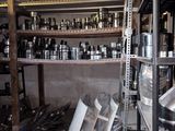 many pots and pans on the shelves in the room