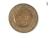 a gold plate with a picture of a man on it