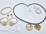 a lot of jewelry on a table with a price tag