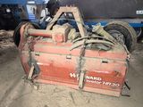 a tractor that is sitting in the dirt near a truck