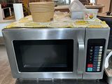 a microwave sitting on top of a table in a kitchen