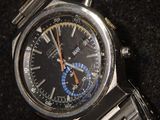 a watch that is sitting on a black surface