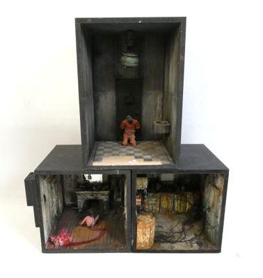a toy bear sitting in a box on top of a table