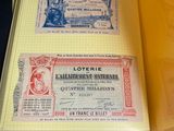 an open yellow folder with a lot of old currency inside of it
