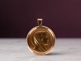 a close up of a gold medal on a marble surface
