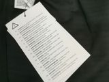 the back of a pair of black pants with a tag on it