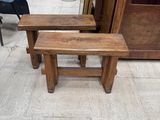 two wooden benches sitting next to each other on the floor