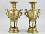 pair of antique brass vases with birds and flowers on them