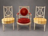 three chairs with red velvet cushions and a gold frame