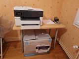 a white printer sitting on top of a wooden table