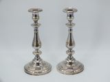 pair of silver candlesticks on a white background