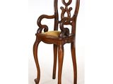 a wooden chair with a yellow cushion on top of it