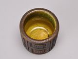 a small brown bowl with a brown rim on a white surface