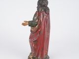 a statue of a man in a red cloak holding his hands out