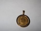 a close up of a gold coin on a white surface