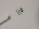 a white plate with a green design on it
