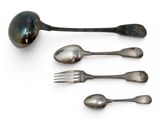 several spoons, forks and spoon rest on a white surface